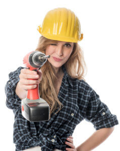 Woman aiming with drill